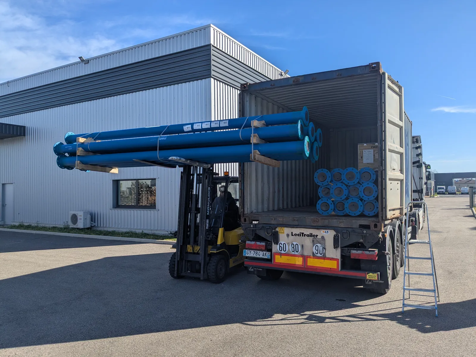Container loading and water infrastructure equipment prepared for international shipment